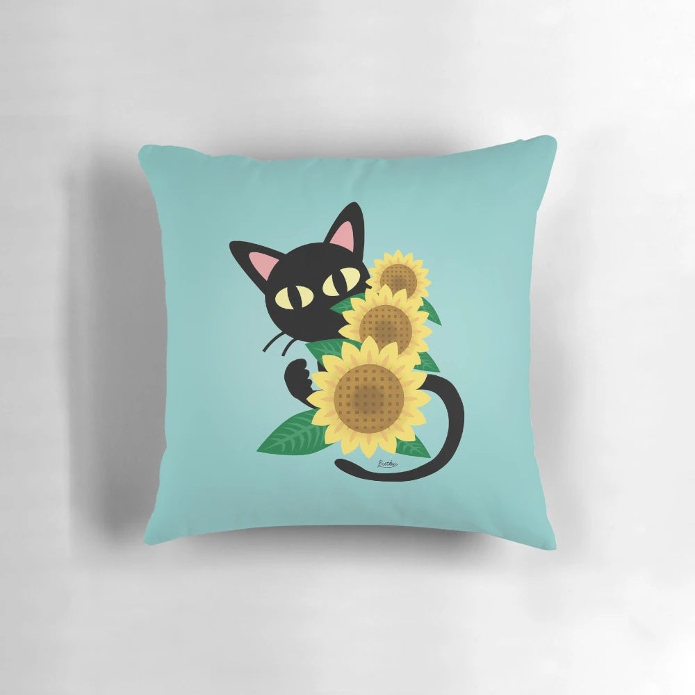 A black cat resting on a sunflower-print pillow, showcasing a charming and whimsical design
