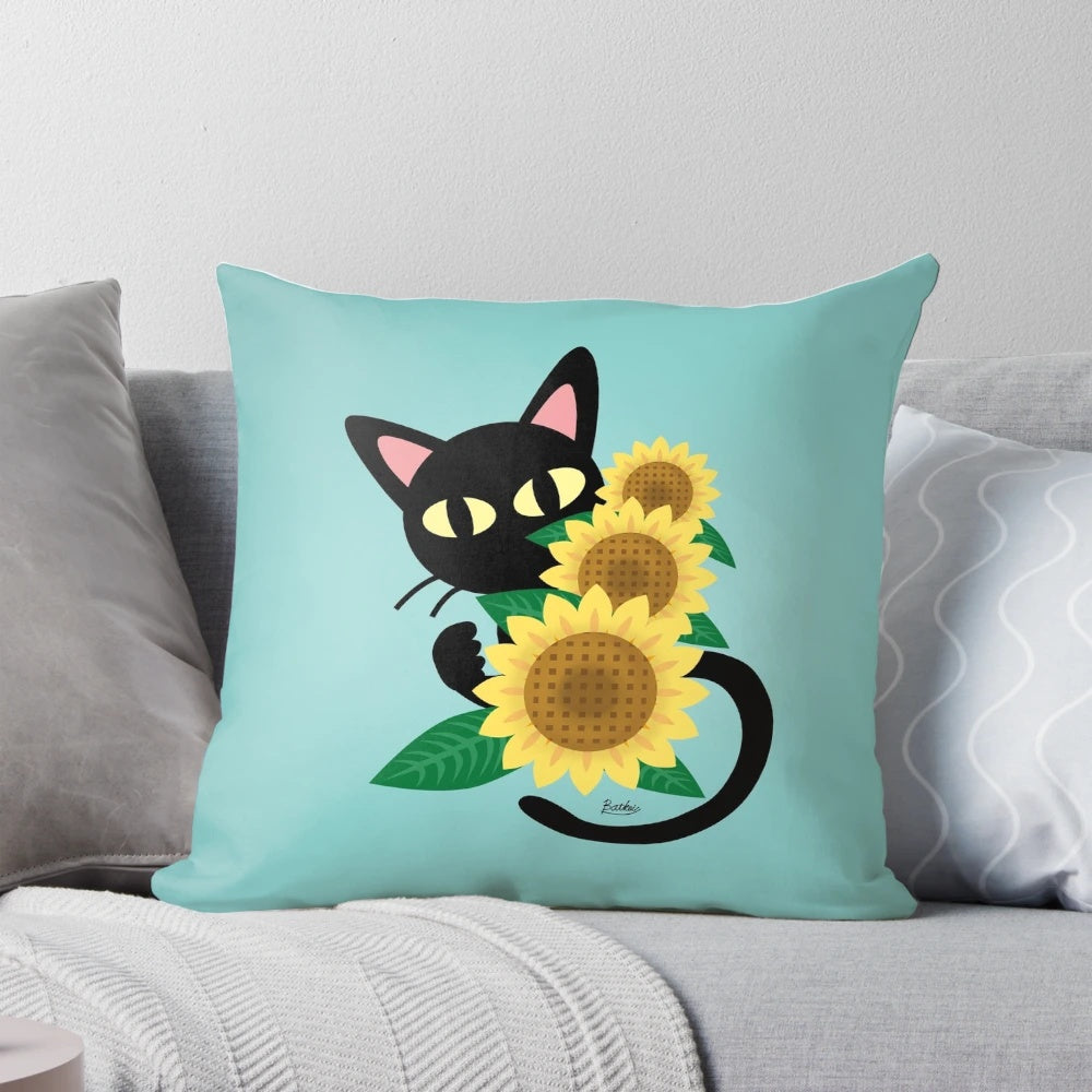 A black cat resting on a sunflower-print pillow, showcasing a charming and whimsical design
