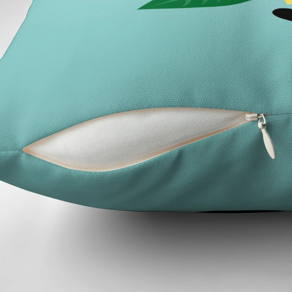 A black cat resting on a sunflower-print pillow, showcasing a charming and whimsical design