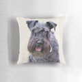 A soft, plush pillow featuring a close-up portrait of a cute black miniature schnauzer dog.