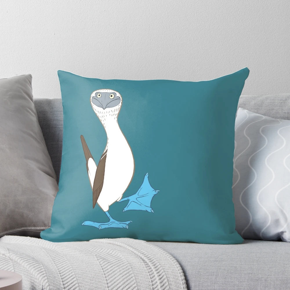 Colorful cartoon image of a blue-footed booby bird on a fluffy white pillow