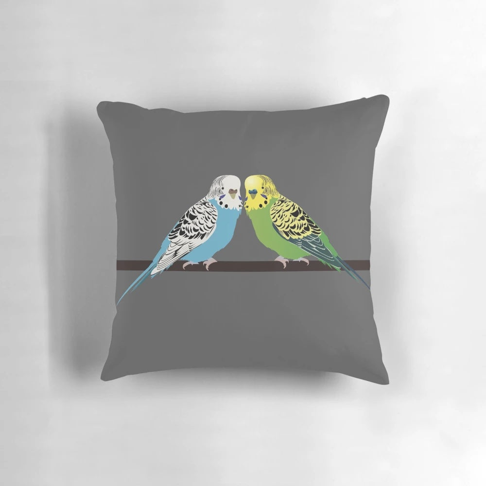 Closeup image of a blue parakeet on a decorative pillow