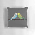 Closeup image of a blue parakeet on a decorative pillow