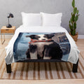 Cute border collie puppy in a snowy winter scene on a soft plush blanket