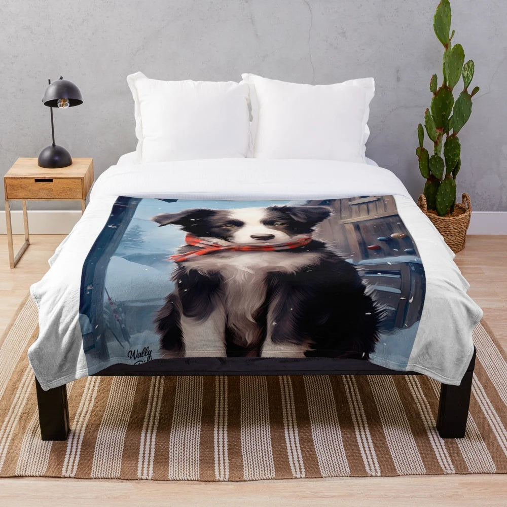 Cute border collie puppy in a snowy winter scene on a soft plush blanket