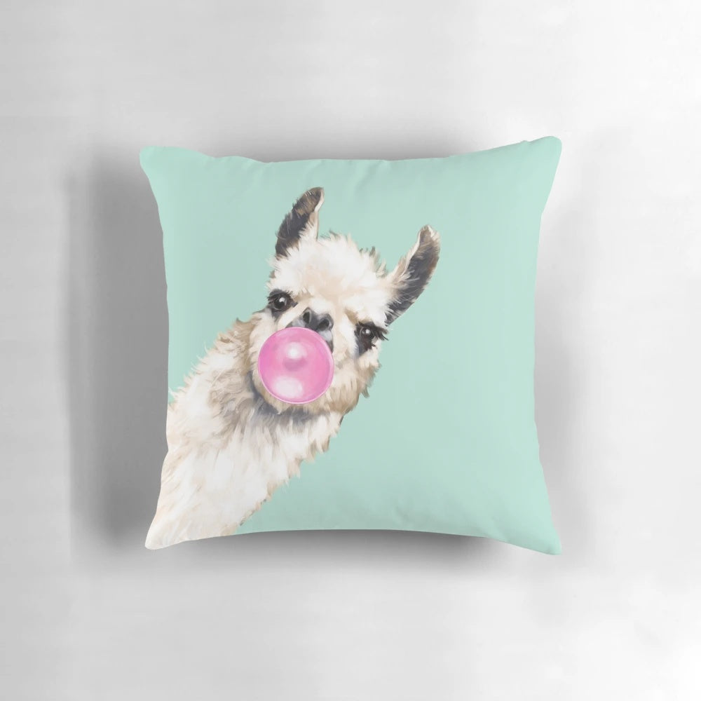Colorful throw pillow featuring a whimsical llama with a bubble gum detail