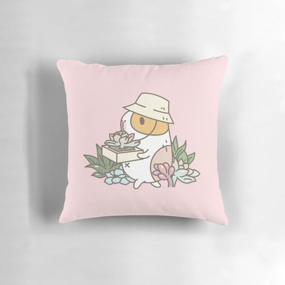 Bubu the guinea pig illustrated on a pink and green succulent-patterned pillow