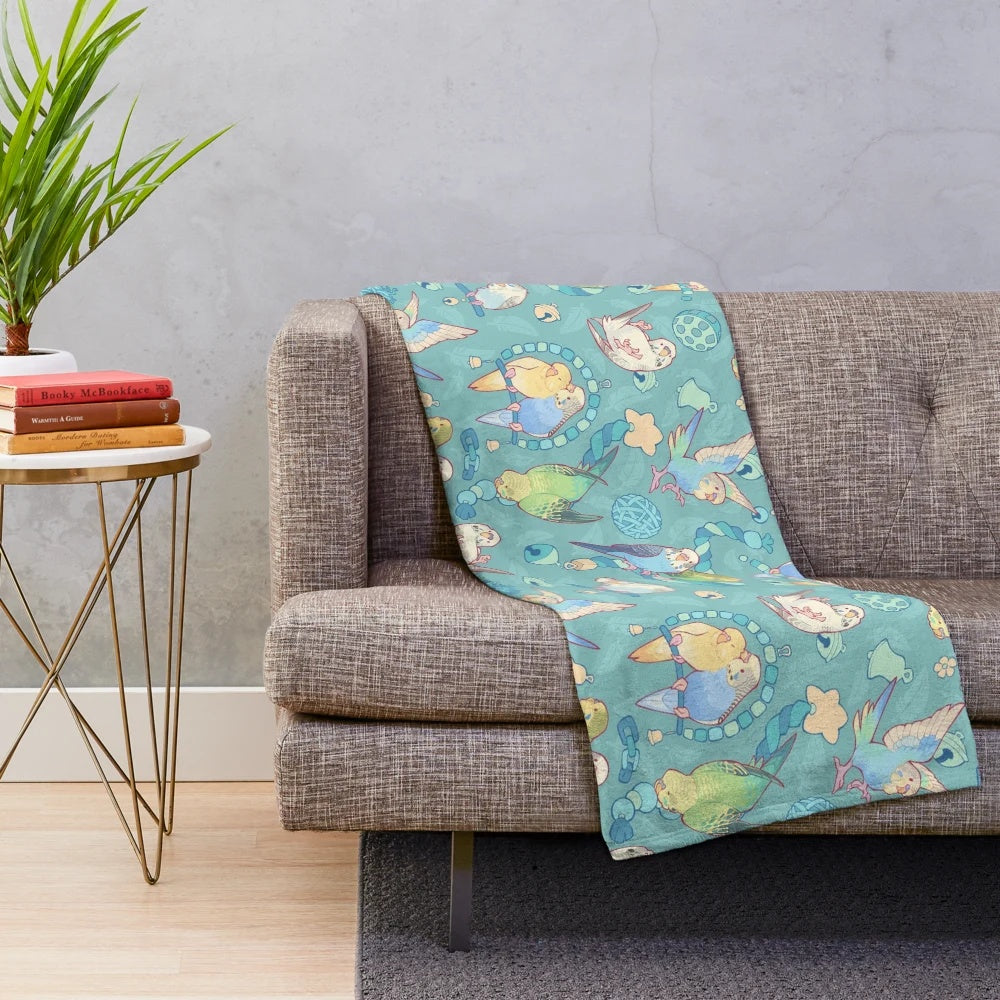 Soft and cuddly plush blanket with a cute budgie bird pattern in teal and blue shades