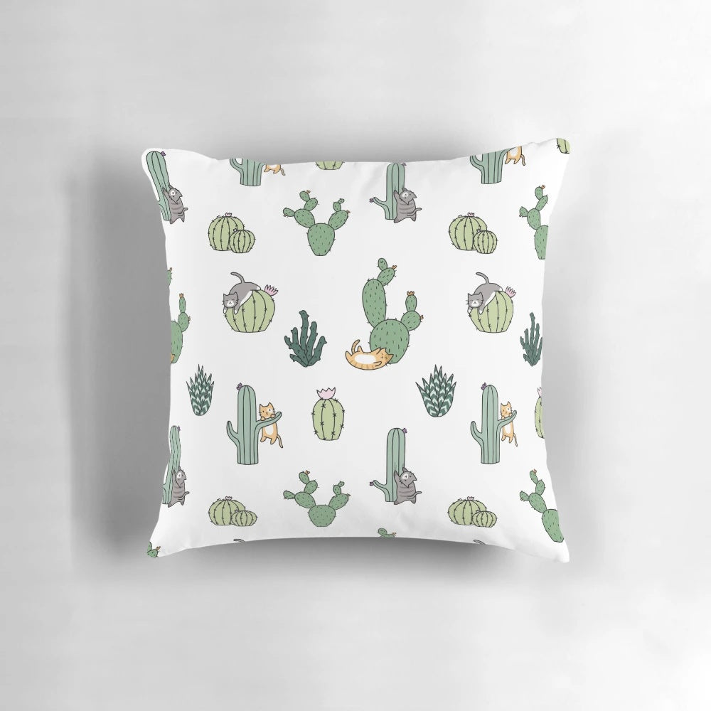 Colorful pillow featuring cute cats among cacti plants
