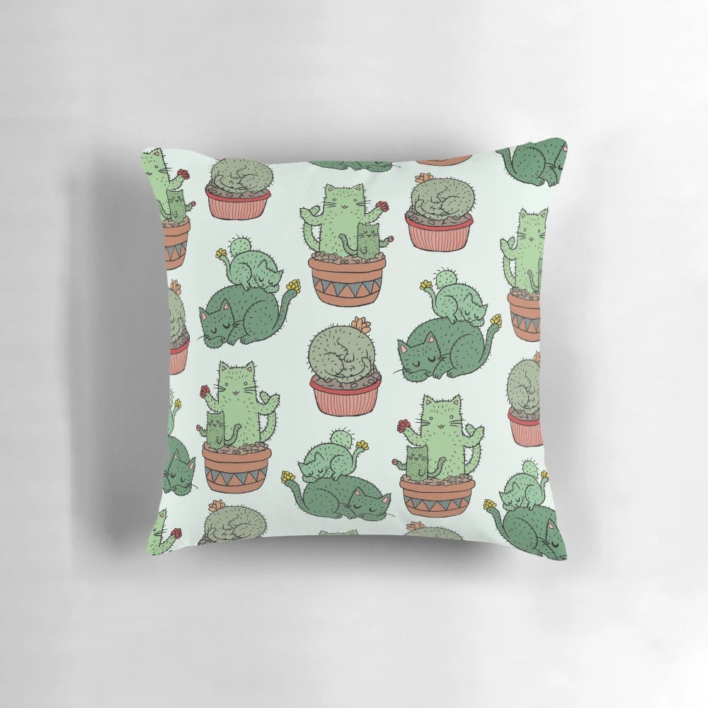 Cozy pillow featuring a playful design of cats among cactus plants