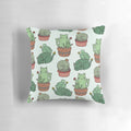 Cozy pillow featuring a playful design of cats among cactus plants