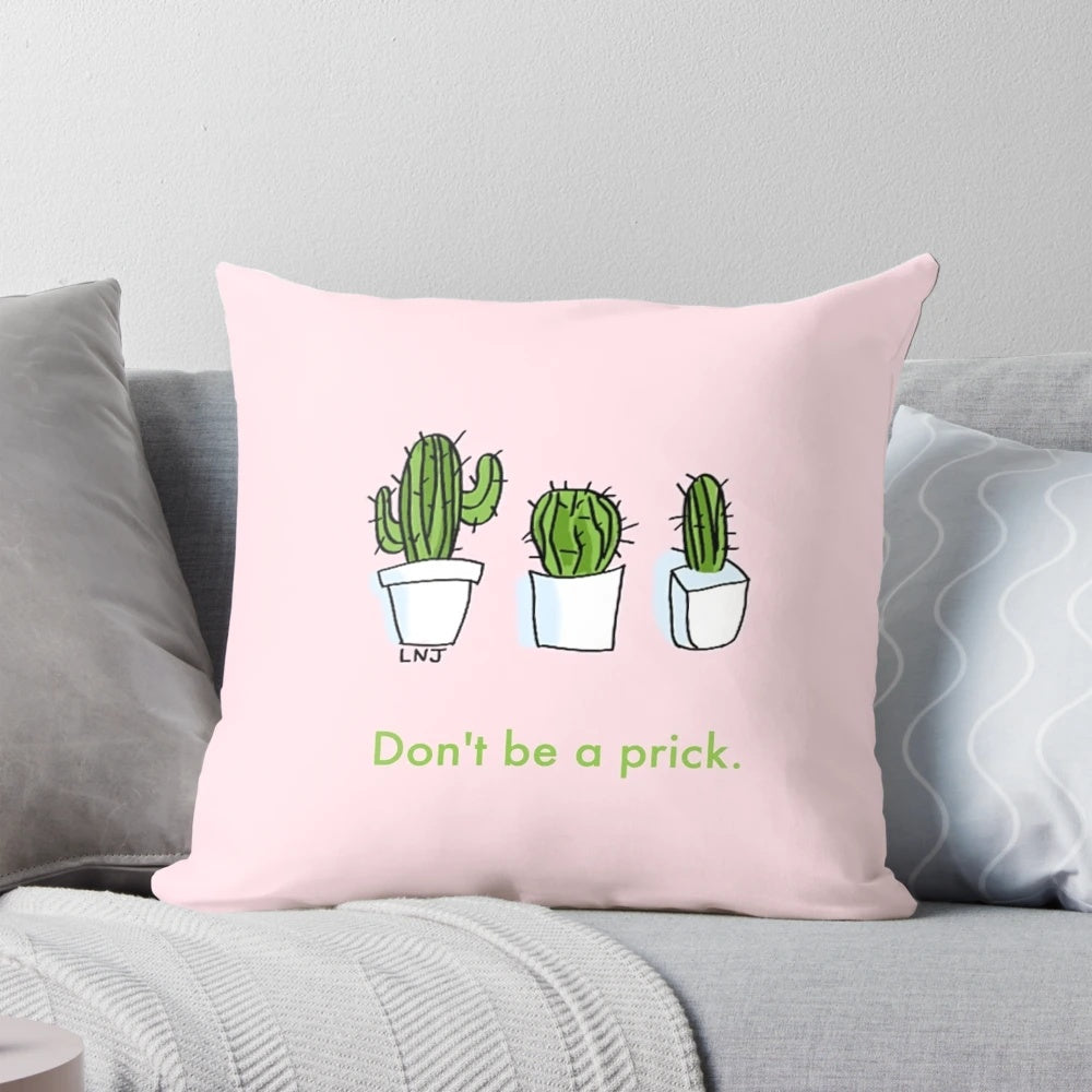 Three pink and green smol cartoon cactus plants on a decorative throw pillow