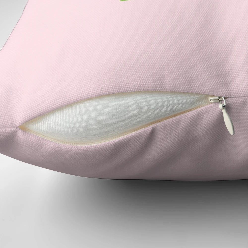 Three pink and green smol cartoon cactus plants on a decorative throw pillow