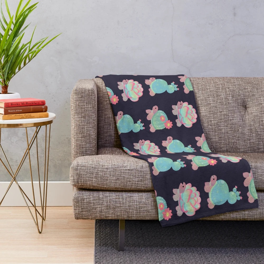 Plush cactus tortoise blanket with a cute, smiling design