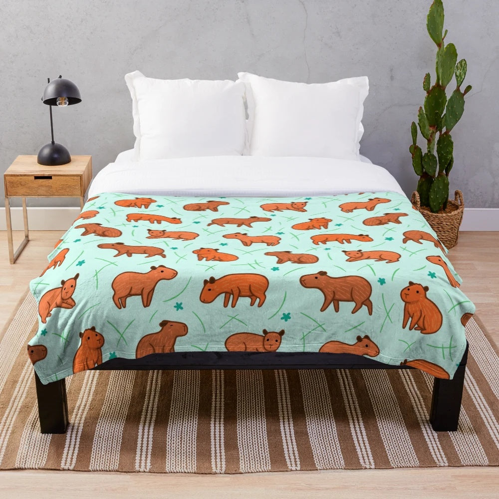 Capybara patterned plush blanket providing soft, warm, and snuggly comfort