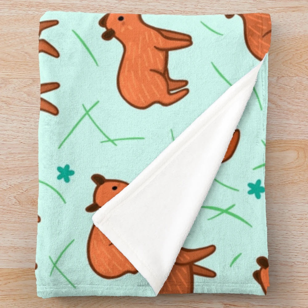 Capybara patterned plush blanket providing soft, warm, and snuggly comfort