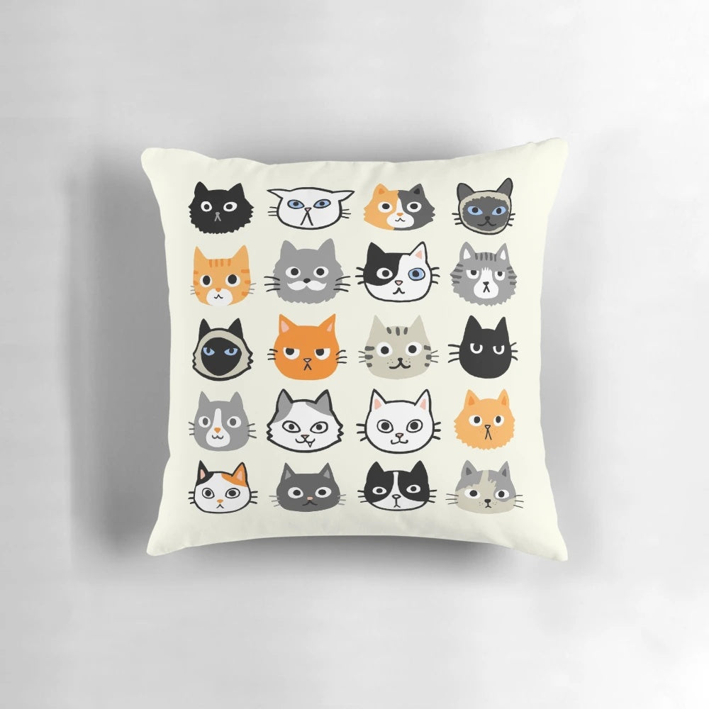 Assorted cat face illustrations printed on a fluffy throw pillow, featuring various cat breeds and patterns