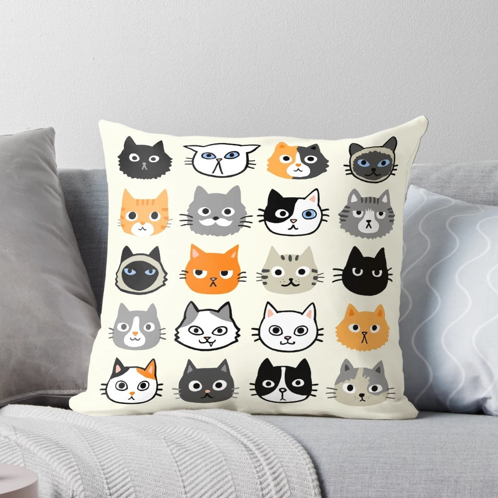 Assorted cat face illustrations printed on a fluffy throw pillow, featuring various cat breeds and patterns