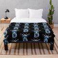 Cute cat wearing blue sunglasses on a cozy plush blanket