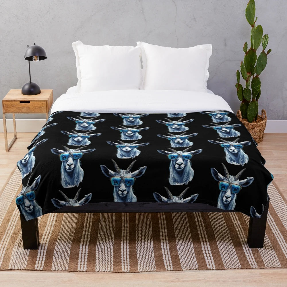 Cute cat wearing blue sunglasses on a cozy plush blanket