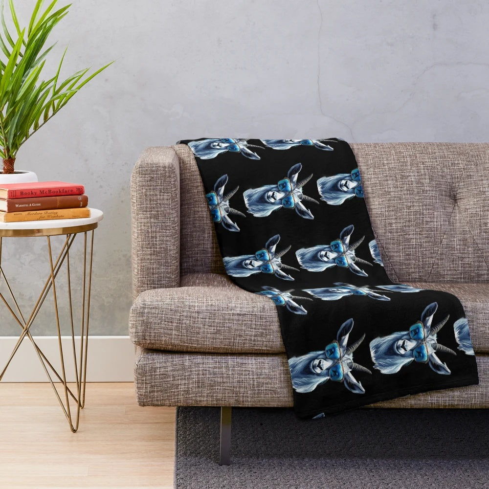 Cute cat wearing blue sunglasses on a cozy plush blanket