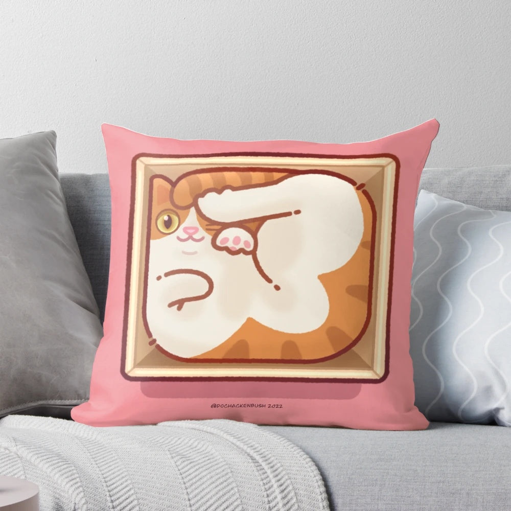 A square-shaped pillow with a cute cat peeking out of a box.
