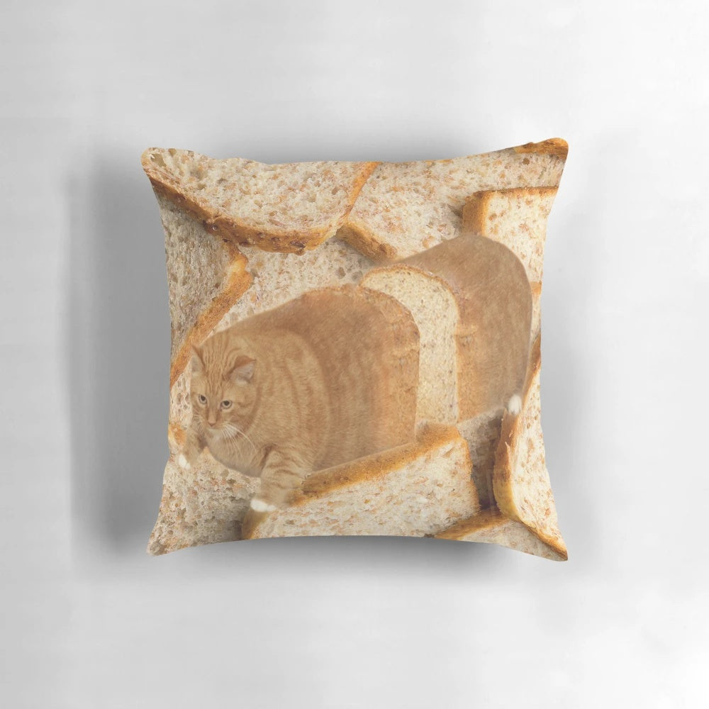 A plush, cat-shaped pillow depicting a cat in a "loaf" position, wearing sunglasses.