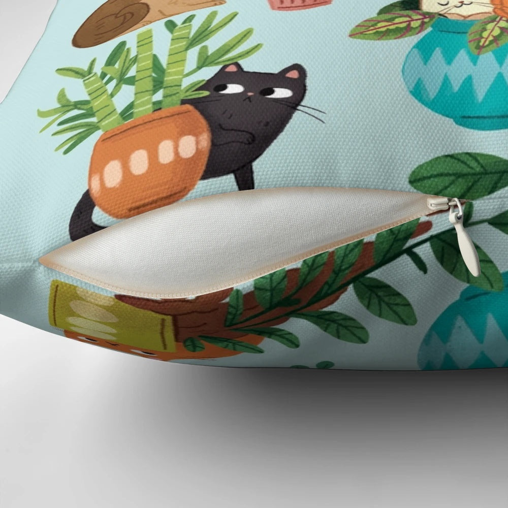 Cute black and tabby cats sitting in a variety of plants on a decorative pillow