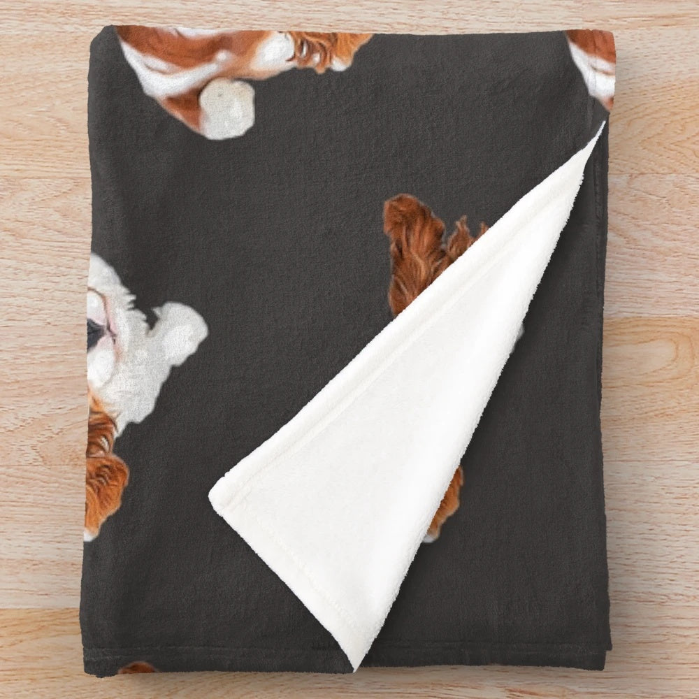 Cute Cavalier King Charles Spaniel puppy on a plush blanket