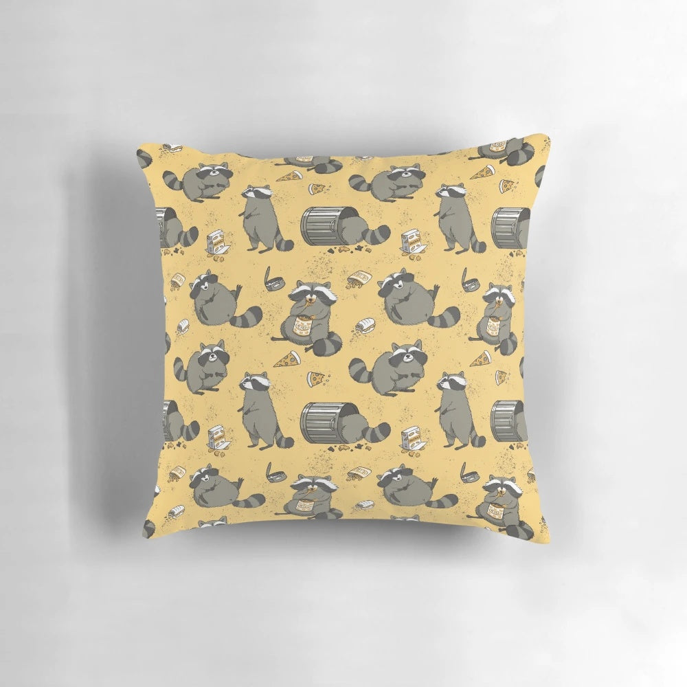 Illustration of a chubby, cute raccoon in a black, yellow, and gray pattern on a decorative pillow
