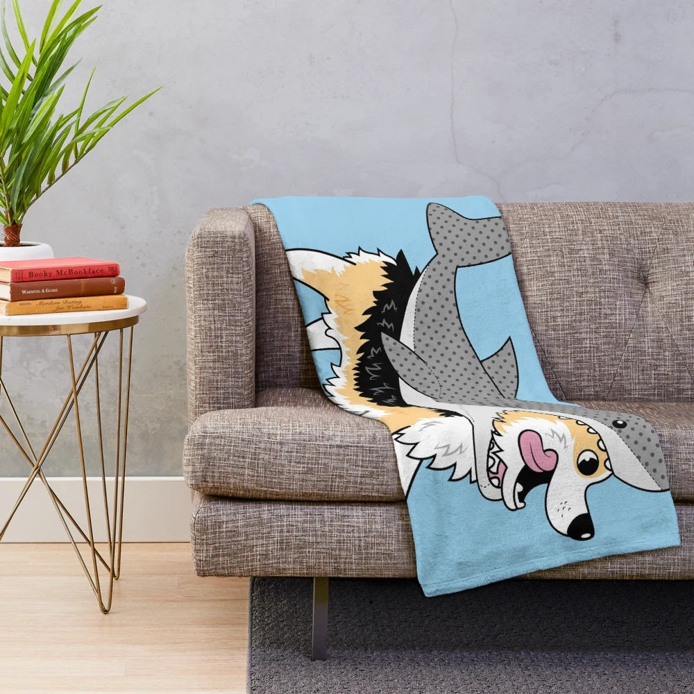 Corgi dog wearing a shark costume on a plush blanket
