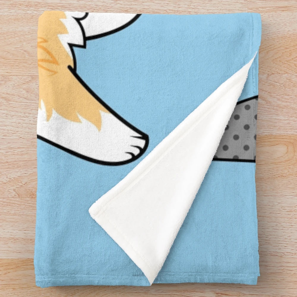 Corgi dog wearing a shark costume on a plush blanket