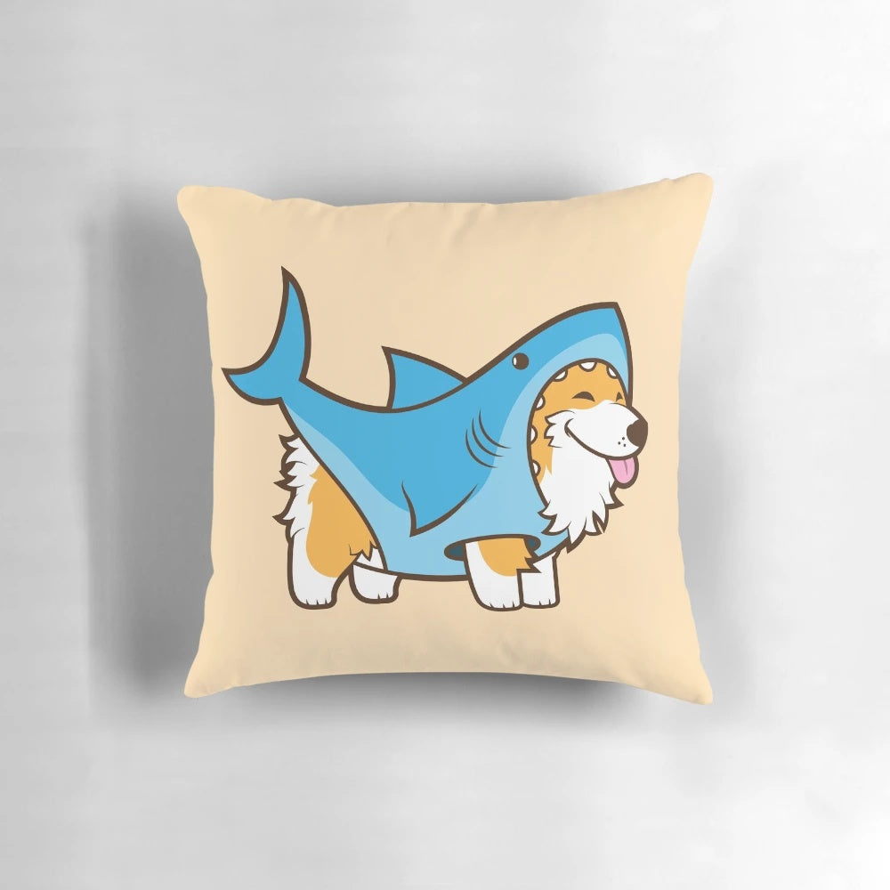 Cute corgi dog wearing a shark costume sitting on a decorative pillow