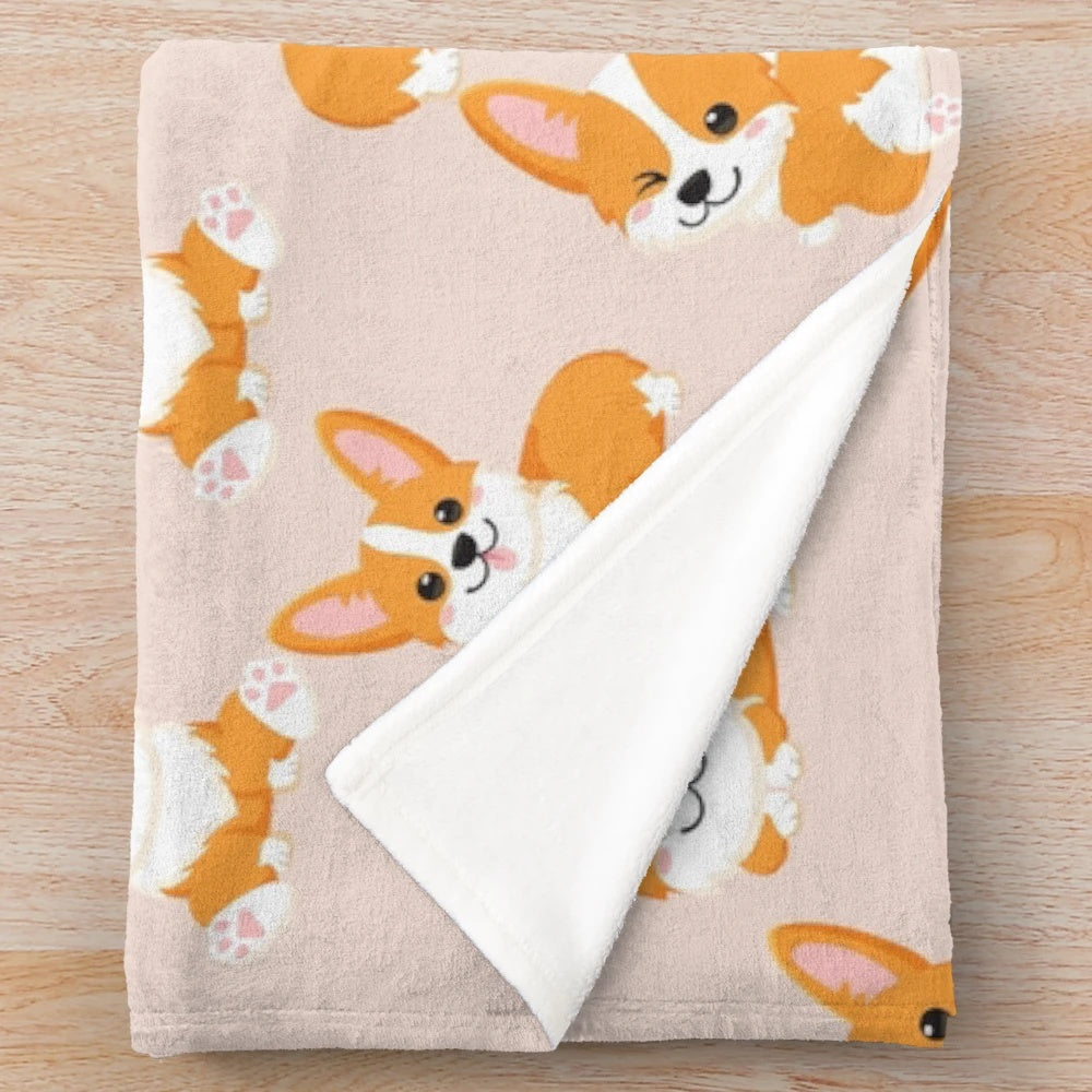 Cute corgi puppy sitting on a soft, plush blanket