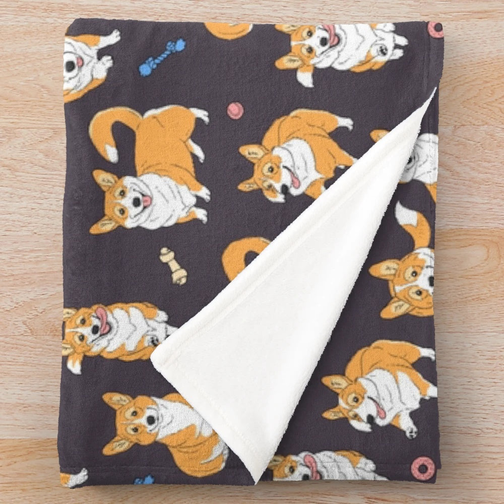 Cute Corgis playing on a grey plush blanket