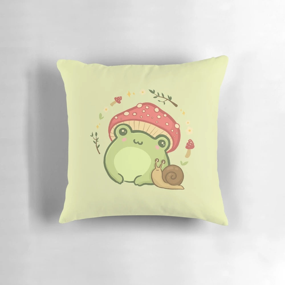 A cute, kawaii-style illustration of a frog wearing a toadstool mushroom hat, sitting next to a snail on a cottagecore-inspired pillow.