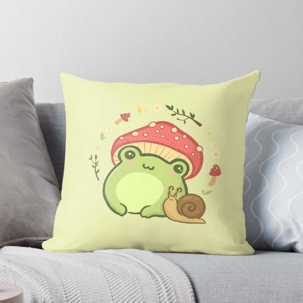 A cute, kawaii-style illustration of a frog wearing a toadstool mushroom hat, sitting next to a snail on a cottagecore-inspired pillow.
