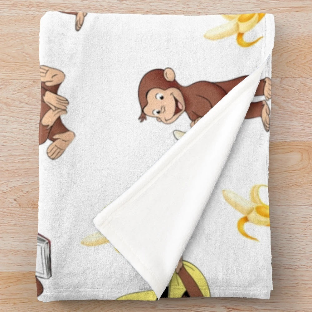 Curious monkey cartoon character on a yellow plush blanket