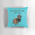 A cozy Christmas pillow featuring an adorable dachshund dog in the snow