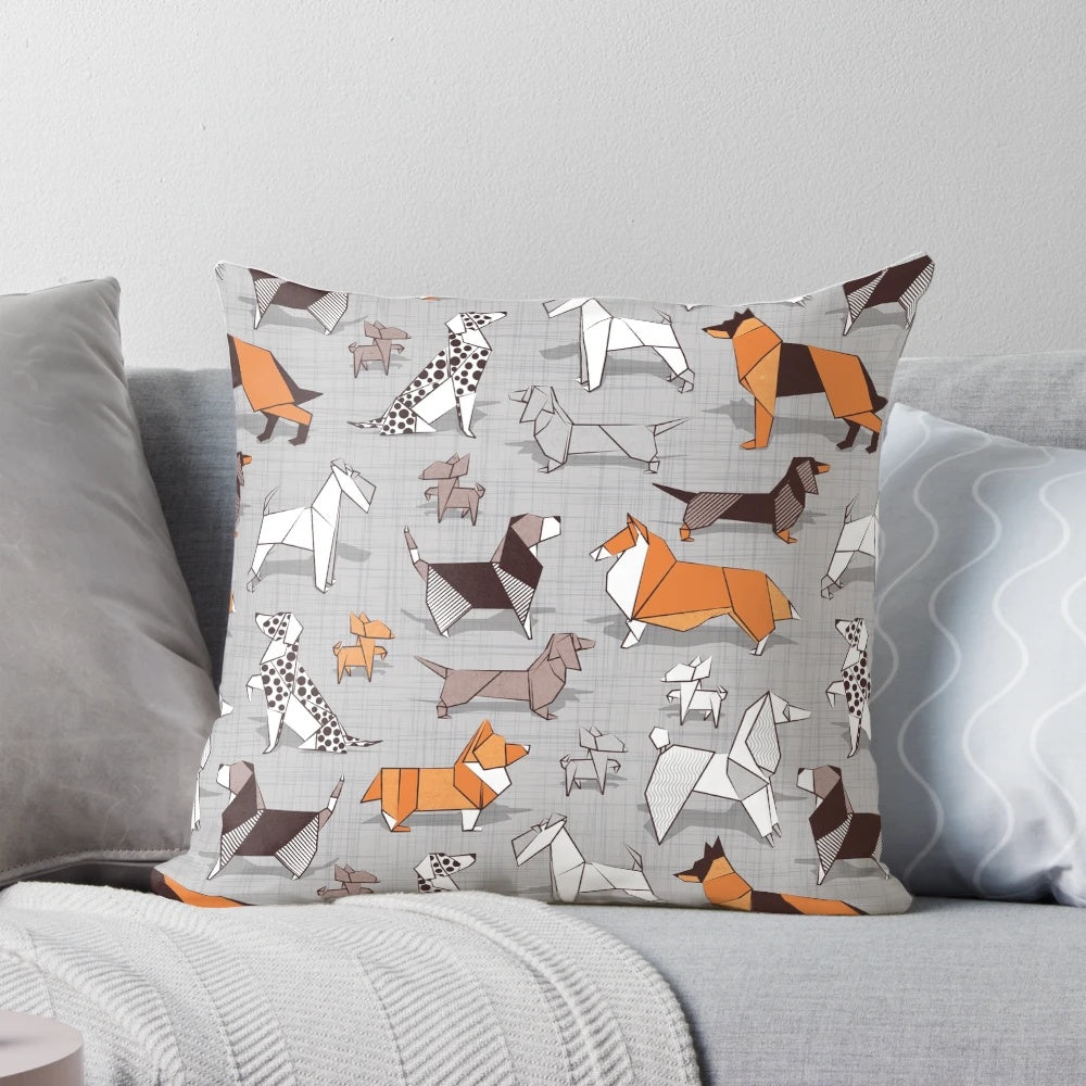 Soft, grey linen pillow with a charming dog illustration pattern in orange, grey, and brown tones.