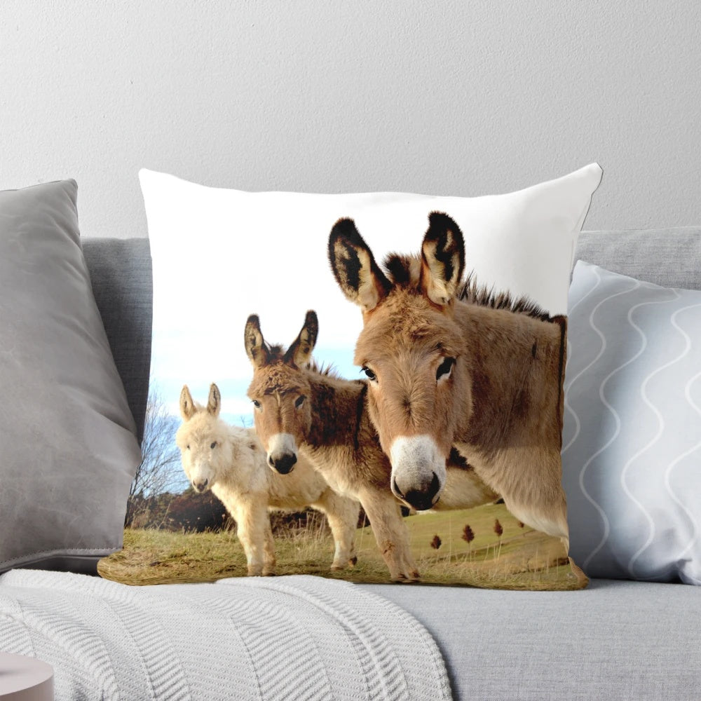 Cozy green pillow featuring a charming trio of donkey plush figures