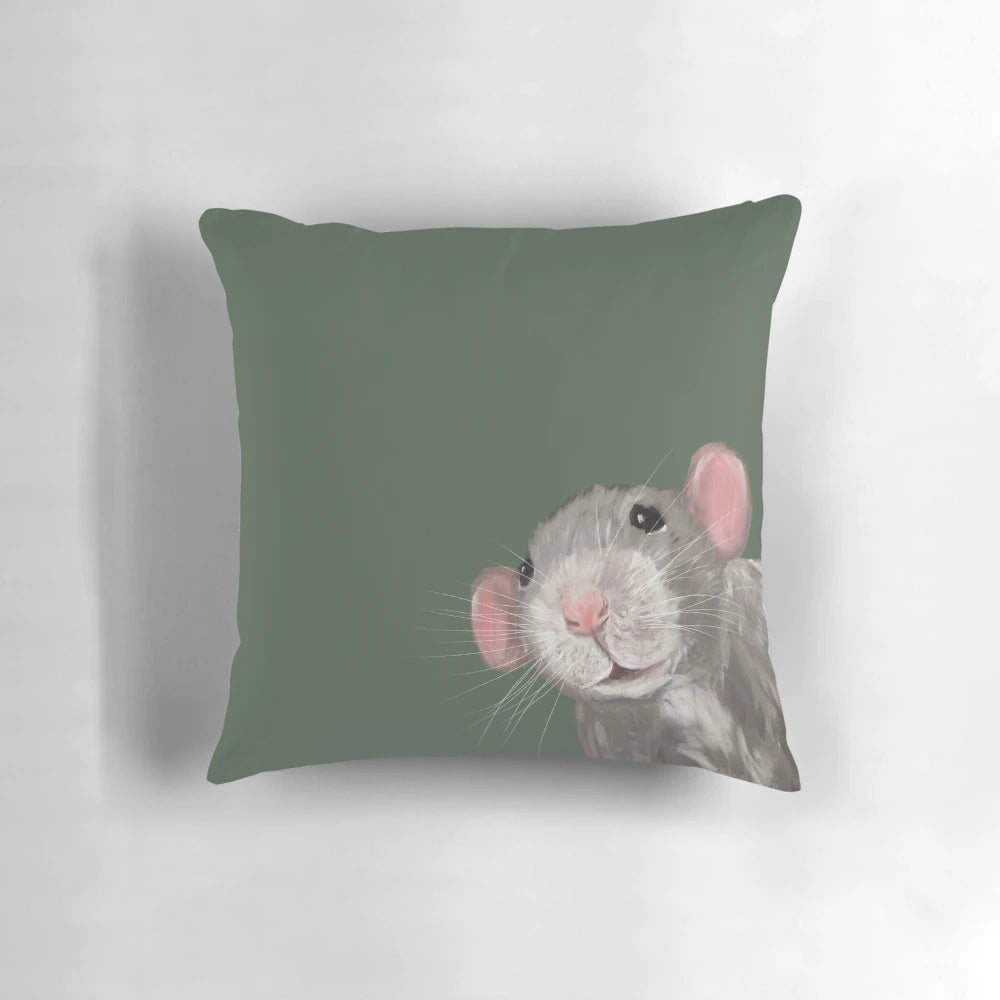 Close-up portrait of a cute green dumbo rat on a decorative pillow.