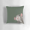 Close-up portrait of a cute green dumbo rat on a decorative pillow.