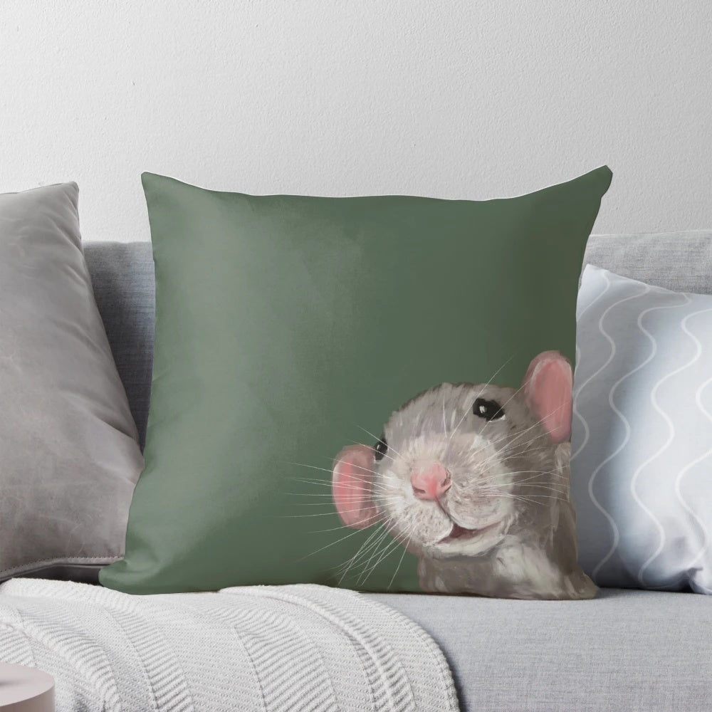 Close-up portrait of a cute green dumbo rat on a decorative pillow.