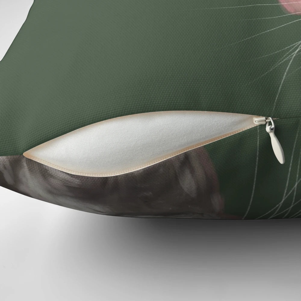 Close-up portrait of a cute green dumbo rat on a decorative pillow.