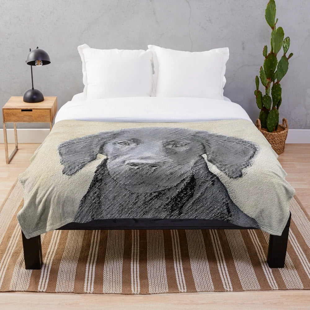 Flat Coated Retriever dog in a cozy plush blanket