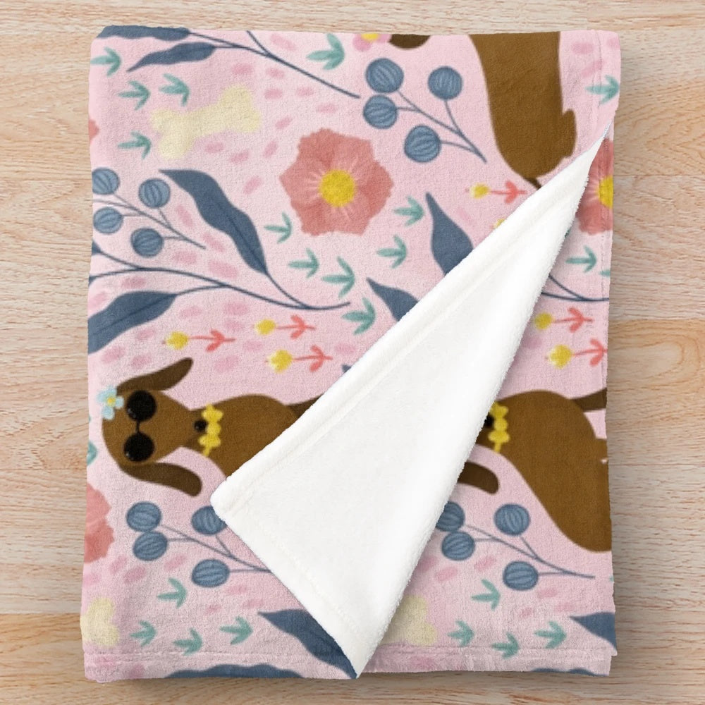 Floral pattern plush blanket featuring sausage dogs
