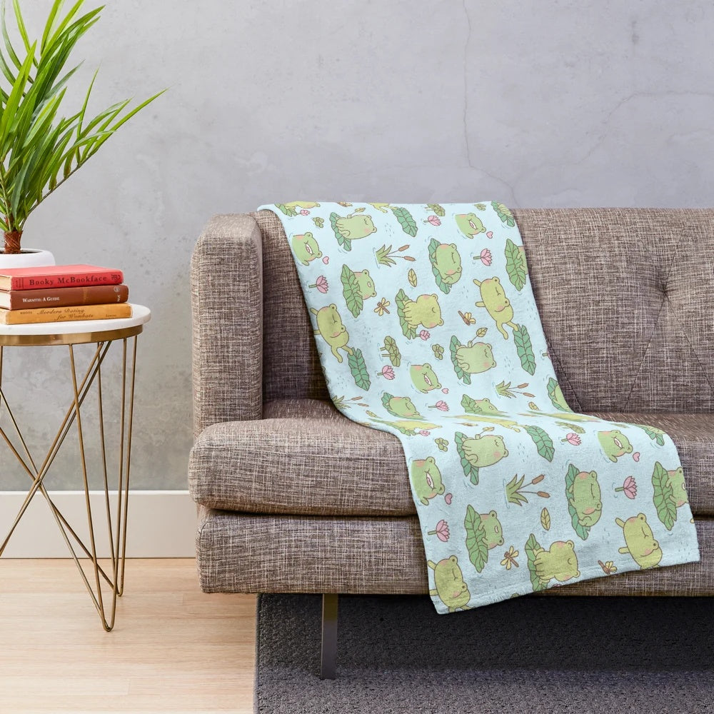 Soft and cozy plush blanket featuring a cute frog and dragonfly pond pattern design