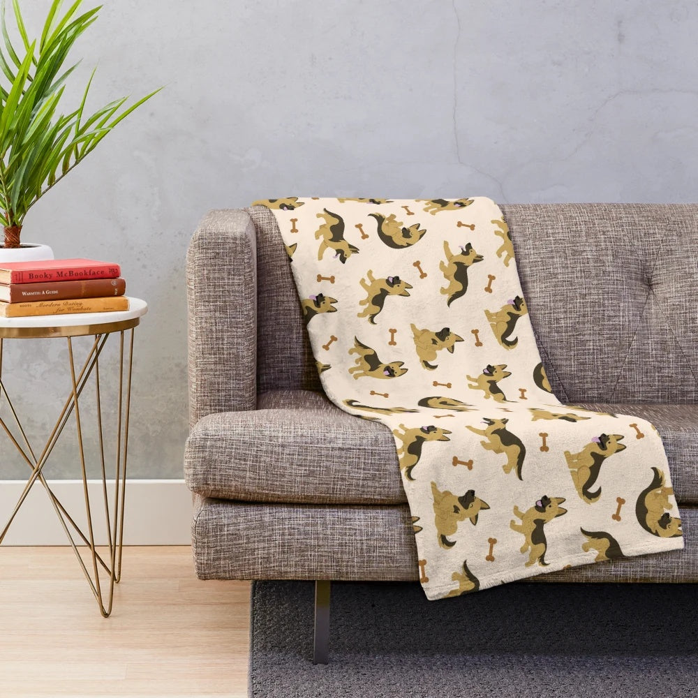 Adorable German Shepherd puppy on a plush blanket with a cute cartoon pattern