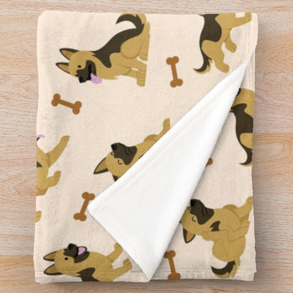 Adorable German Shepherd puppy on a plush blanket with a cute cartoon pattern